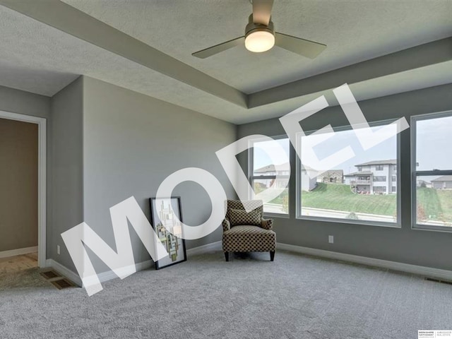 living area featuring a wealth of natural light, carpet floors, and ceiling fan