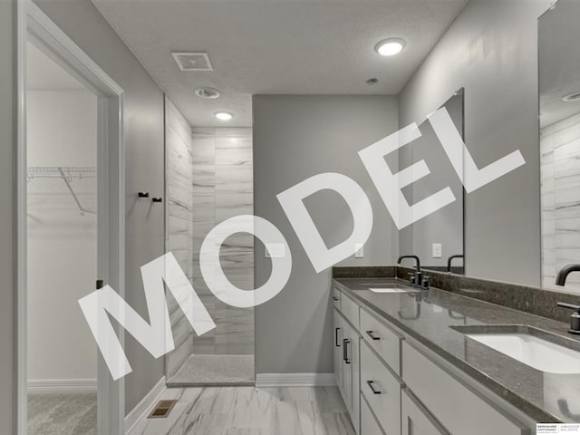 bathroom featuring dual sinks, vanity with extensive cabinet space, and tile floors