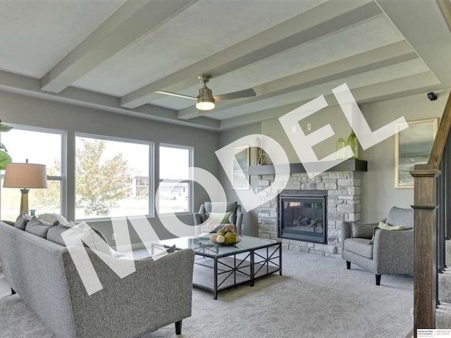 living room featuring beamed ceiling, a fireplace, ceiling fan, and carpet