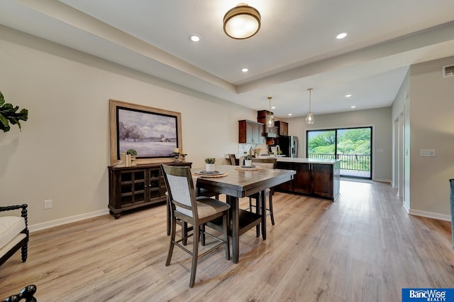 dining space with light hardwood / wood-style floors