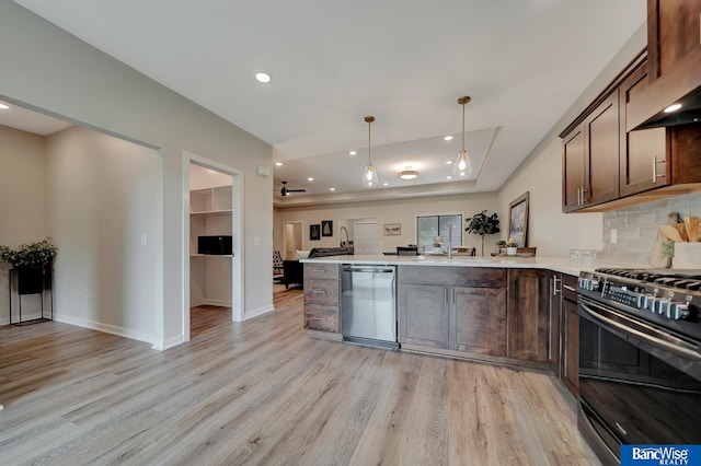 kitchen with stainless steel dishwasher, gas stove, light hardwood / wood-style floors, and backsplash