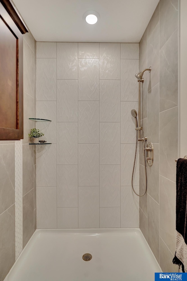 bathroom with tiled shower