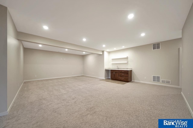 basement featuring light carpet