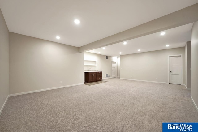 basement featuring light carpet