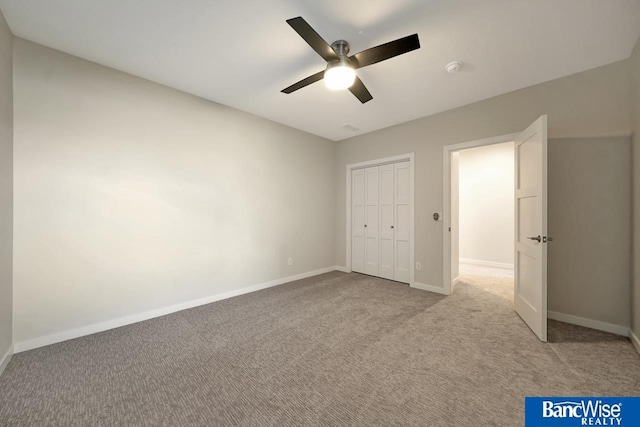 unfurnished bedroom with light colored carpet, a closet, and ceiling fan