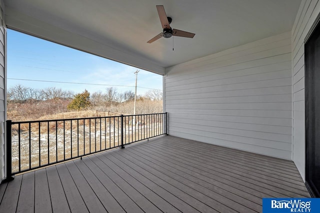 wooden deck featuring ceiling fan