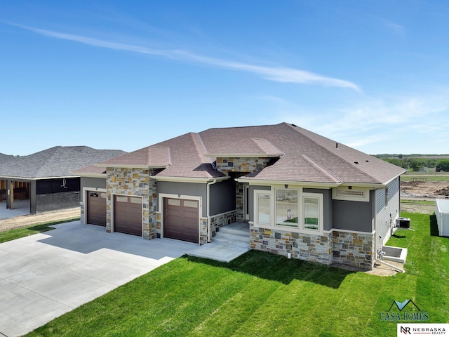 view of front of home with a garage, a front yard, and a carport