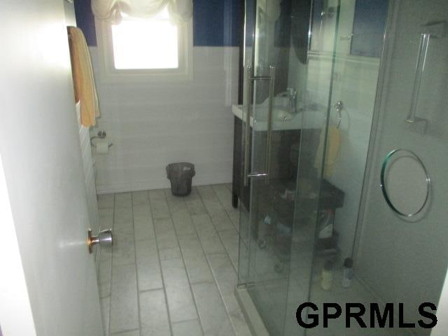 bathroom featuring a shower with shower door