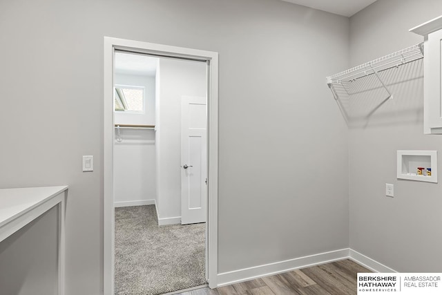 washroom with hardwood / wood-style flooring and hookup for a washing machine