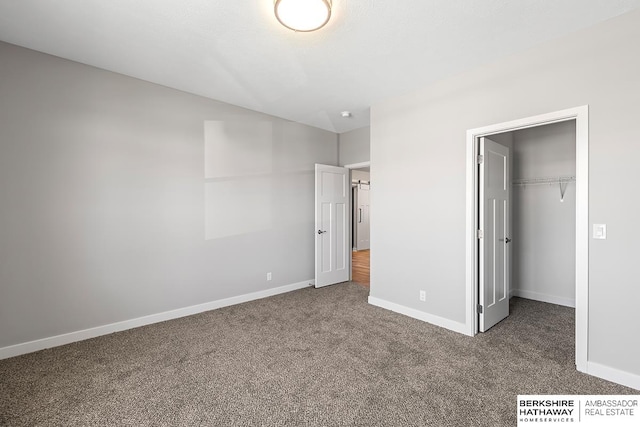 unfurnished bedroom with carpet floors and a closet