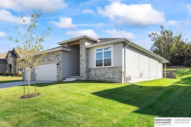 view of front of home with a garage and a front lawn