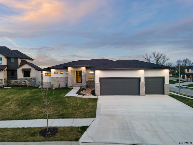 prairie-style house with a garage and a yard