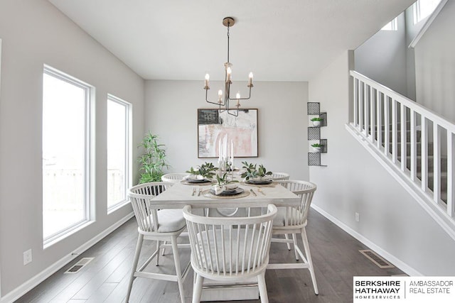 dining space featuring hardwood / wood-style flooring and a notable chandelier