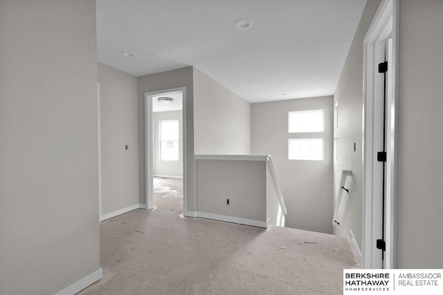 unfurnished room featuring plenty of natural light and concrete flooring