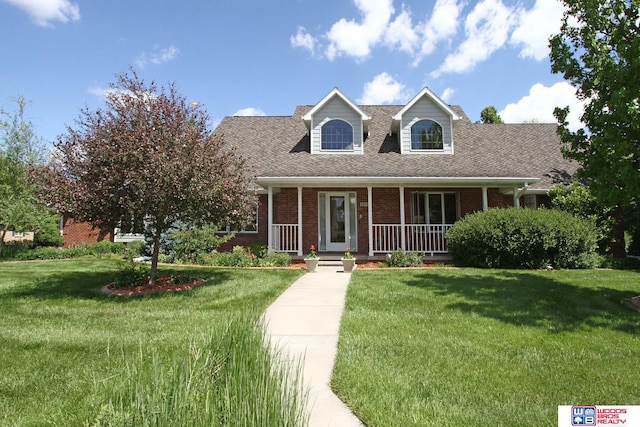 cape cod home with a front lawn and a porch