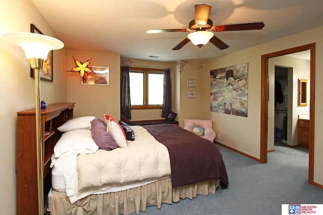 carpeted bedroom with ceiling fan and ensuite bath