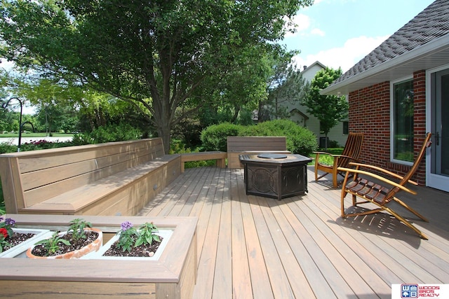 wooden deck with a fire pit