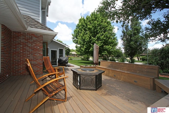 deck featuring an outdoor fire pit