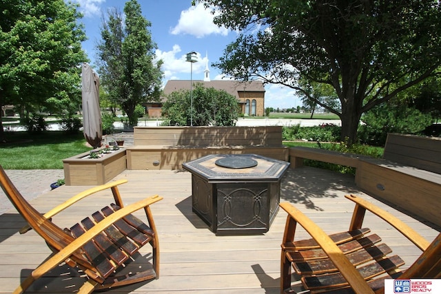 wooden terrace featuring a fire pit