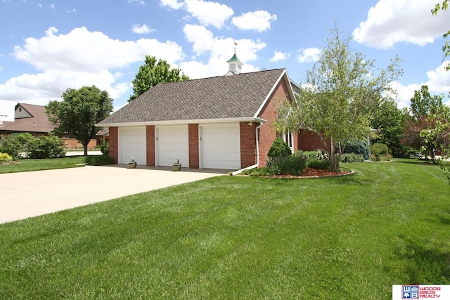 exterior space with a yard and a garage