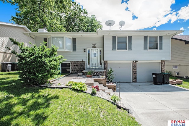 bi-level home with a garage and a front yard