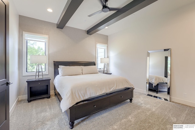 bedroom with ceiling fan, beamed ceiling, and light carpet