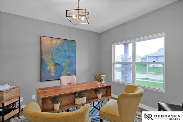 office with plenty of natural light and a notable chandelier