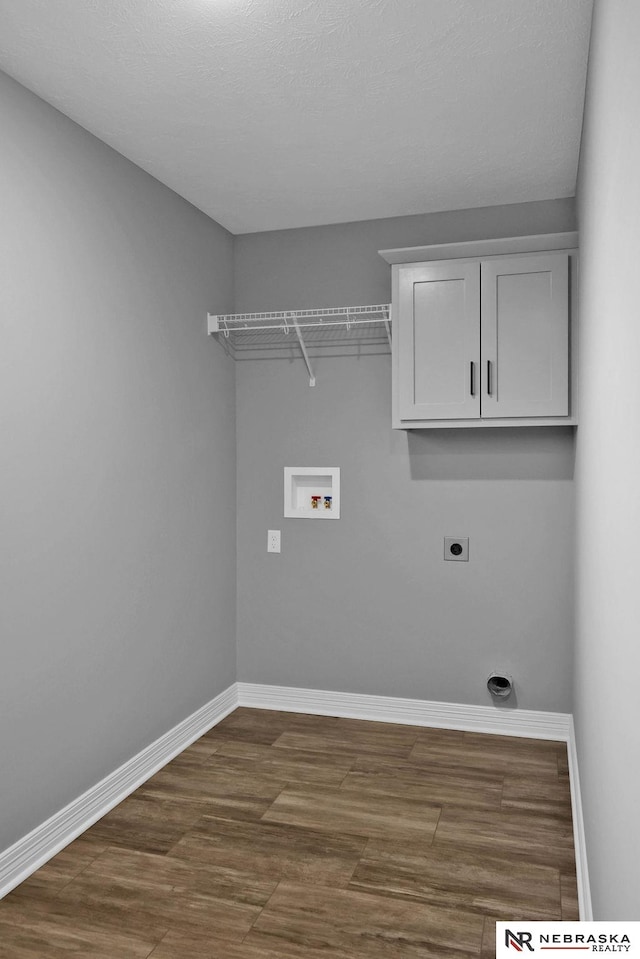 washroom featuring dark hardwood / wood-style floors, electric dryer hookup, and washer hookup