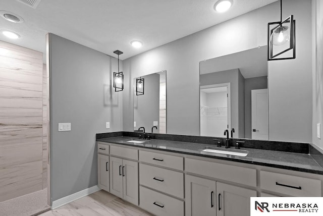 bathroom featuring dual bowl vanity