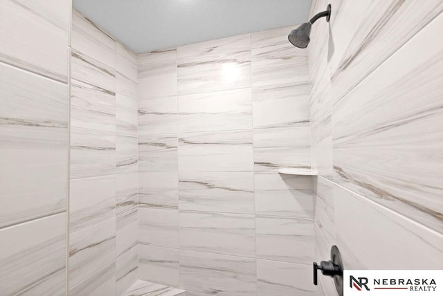 bathroom with a tile shower