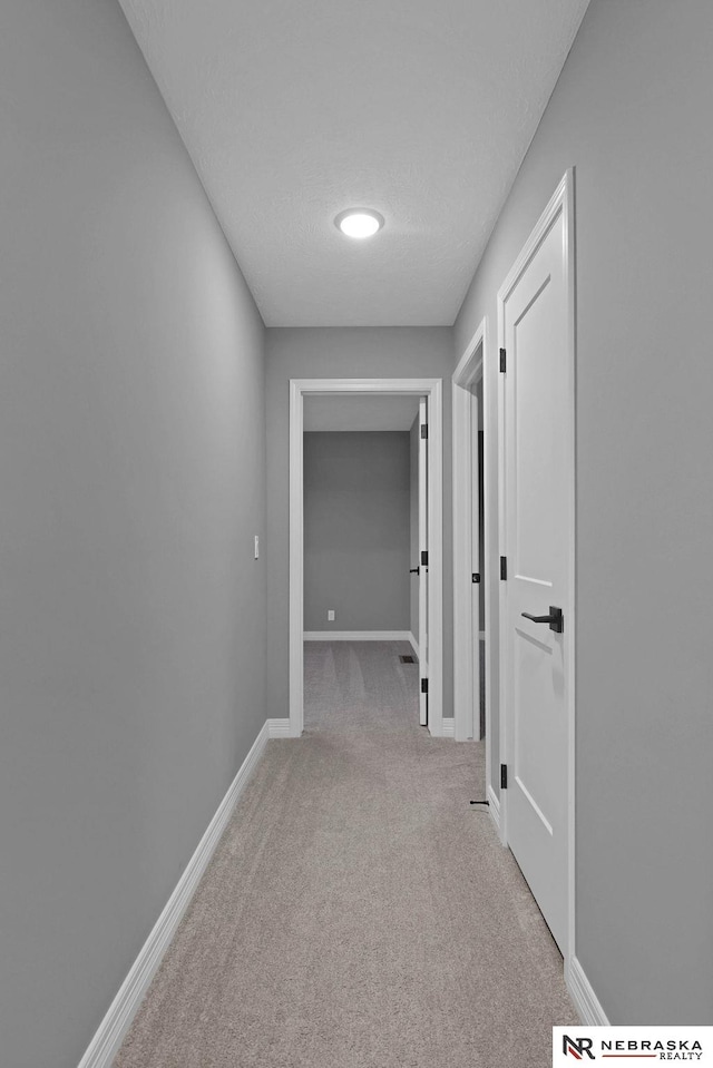 corridor featuring light carpet