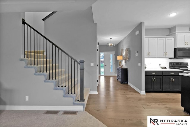 foyer entrance with light hardwood / wood-style flooring