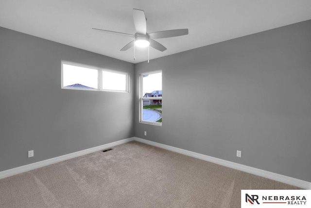 spare room featuring carpet and ceiling fan