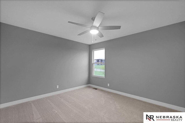 empty room with ceiling fan and carpet floors