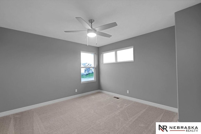 unfurnished room featuring ceiling fan and carpet floors