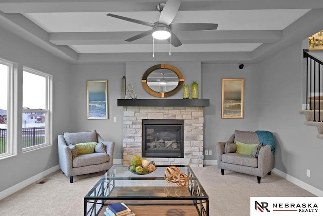 carpeted living room featuring ceiling fan, a fireplace, and a wealth of natural light