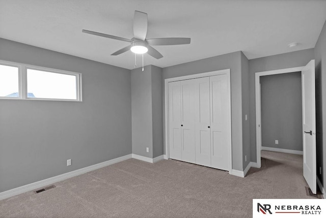 unfurnished bedroom featuring carpet flooring, a closet, and ceiling fan