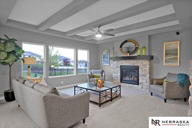 living room with beam ceiling, carpet, ceiling fan, and a fireplace