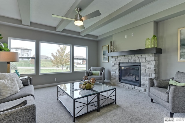 living room featuring a fireplace, beam ceiling, carpet flooring, and ceiling fan