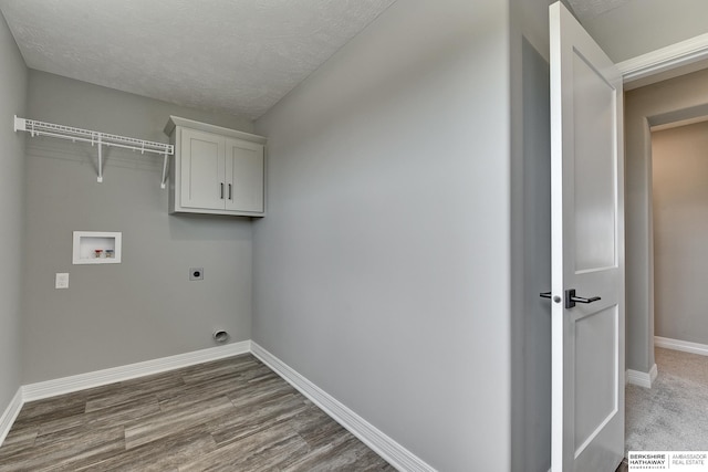 washroom featuring cabinets, washer hookup, hookup for an electric dryer, wood-type flooring, and a textured ceiling