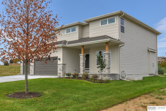 view of front facade featuring a front yard, a porch, and a garage