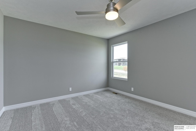 spare room with carpet floors and ceiling fan