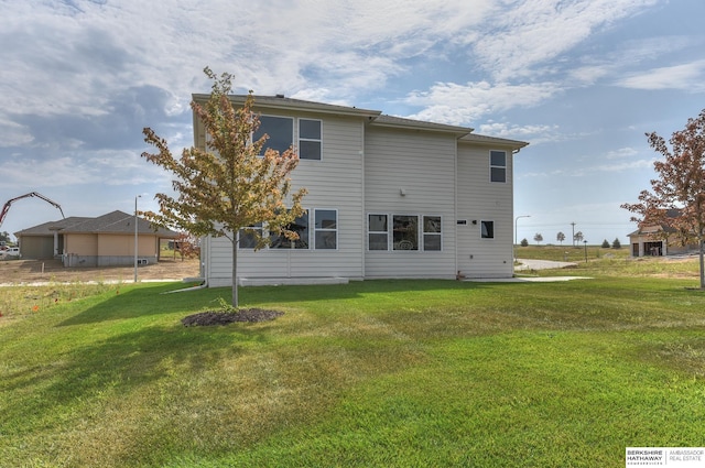 rear view of property featuring a yard