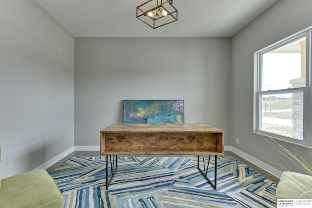 office with plenty of natural light and a chandelier