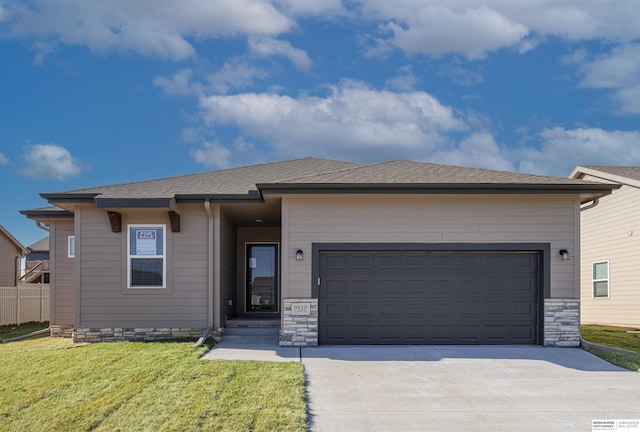 view of front of home featuring a garage and a front lawn