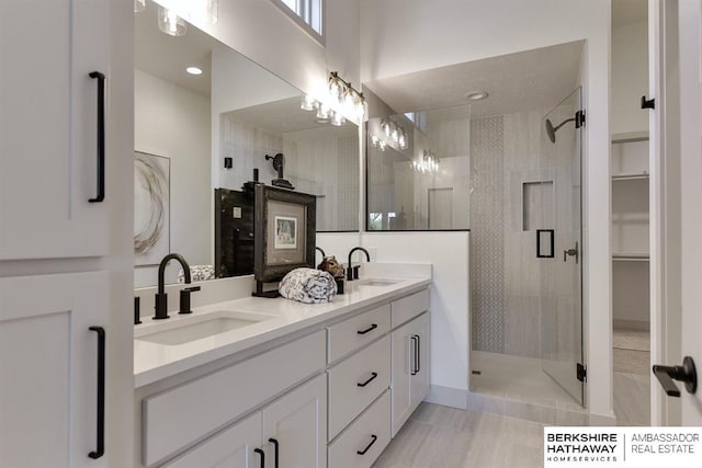 bathroom with tile patterned flooring, vanity, and an enclosed shower