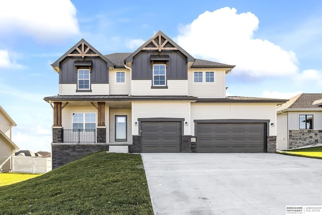 craftsman inspired home with covered porch, a garage, and a front lawn