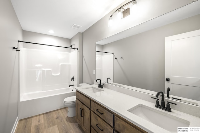 full bathroom featuring vanity, toilet, shower / bathing tub combination, and hardwood / wood-style flooring