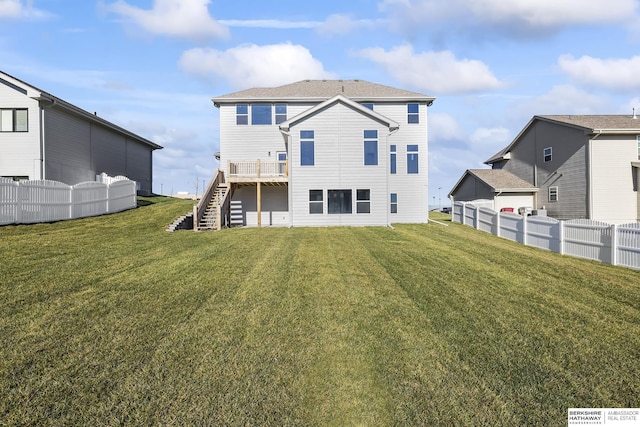 rear view of property featuring a yard