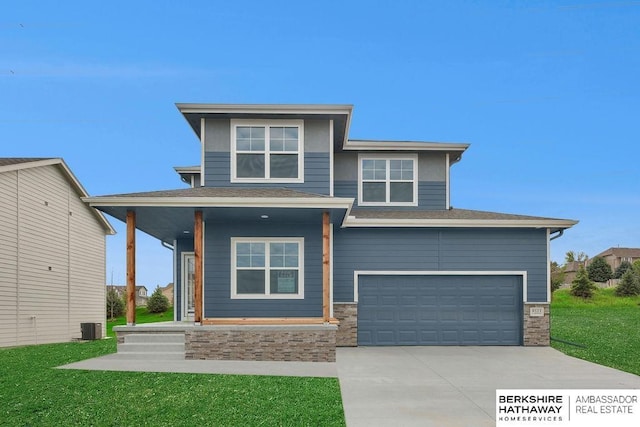 prairie-style house featuring a garage, a front yard, central AC unit, and covered porch